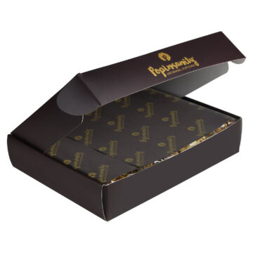 Popinsanity Gourmet Popcorn Sampler Gift Box, partially open, with elegant dark gift paper beautifully concealing the premium artisanal popcorn selection inside. Perfect for a luxurious reveal or a sophisticated popcorn gift.