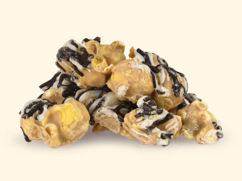 Luxury popcorn coated in a rich, savory-sweet cashew butter and topped with a dual dark and white chocolate drizzle.