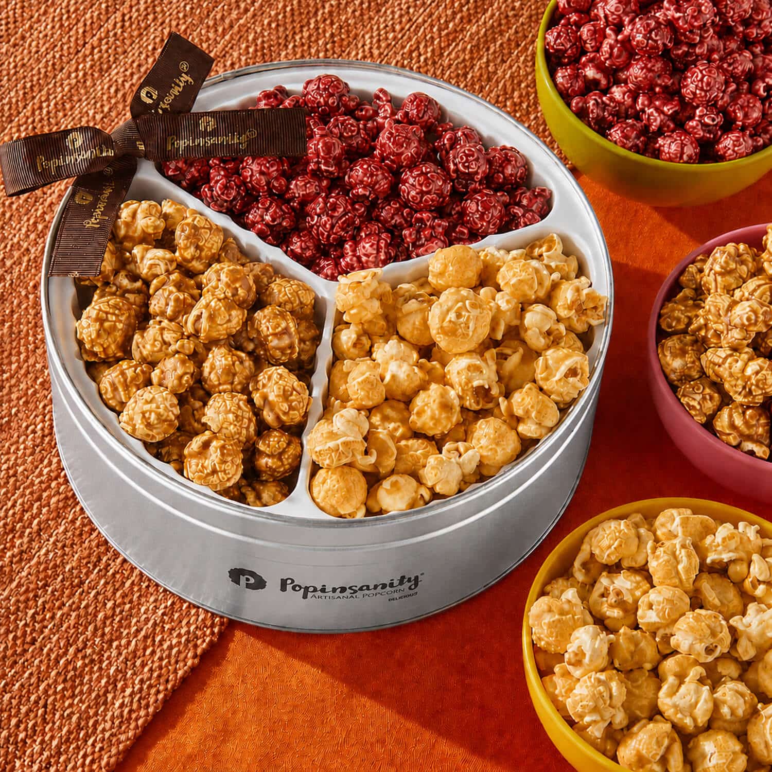 RHTRITIN-3 Rosh Hashanah gourmet popcorn tin with Pomegranate, Apples & Honey, and Cinnamon Baked Apple flavors, tied with brown ribbon